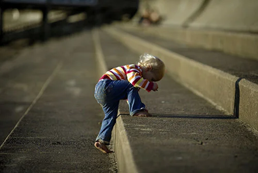 Kid climbing high step